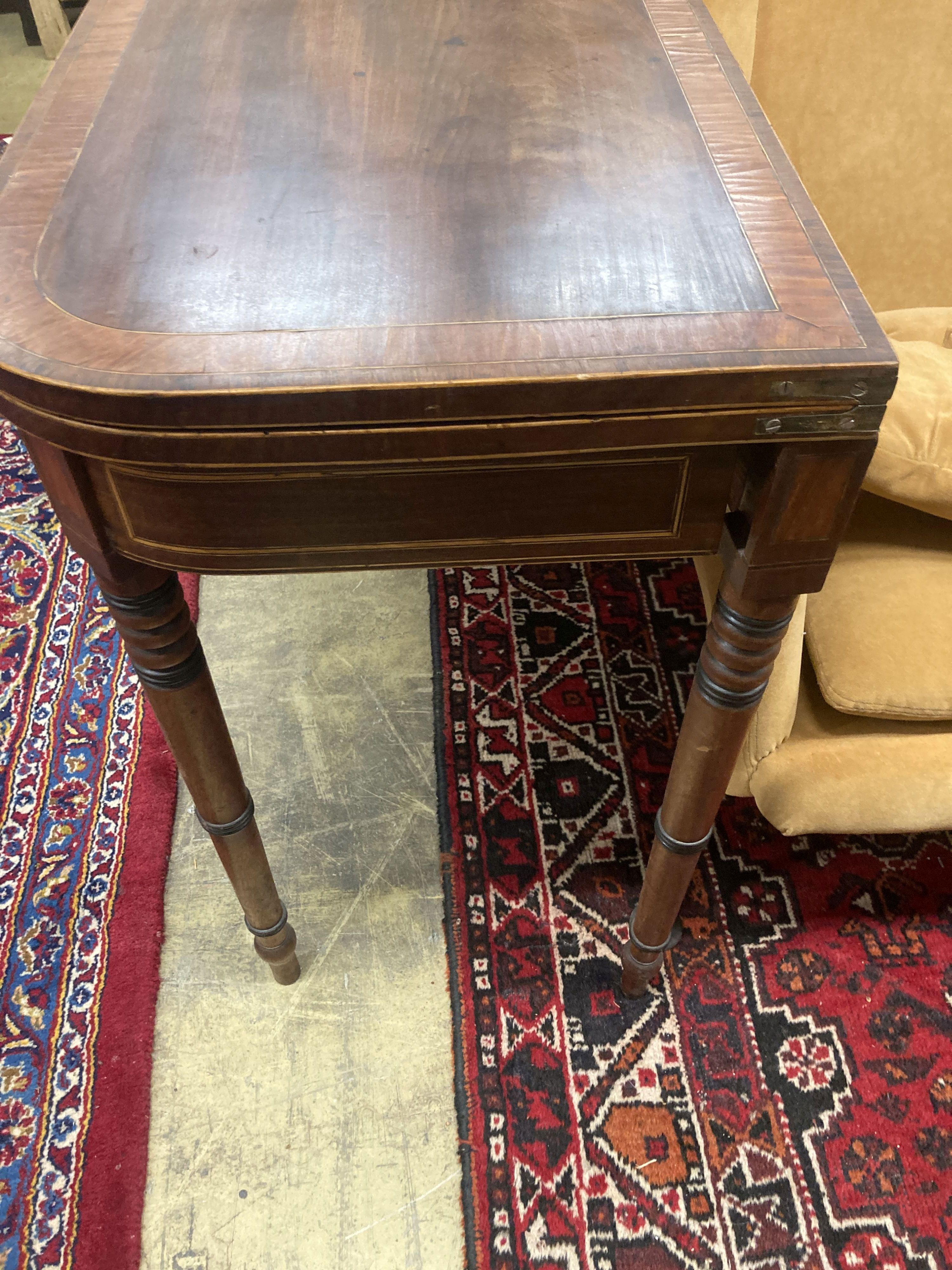 A George IV satinwood banded mahogany folding card table, width 90cm, depth 44cm, height 73cm